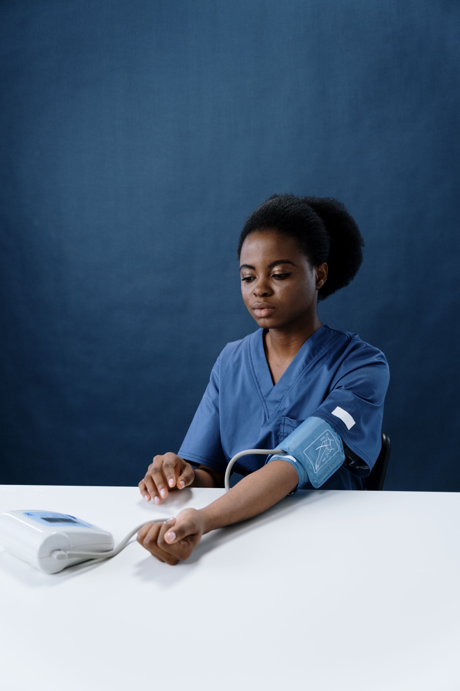 A woman checking her own blood pressure